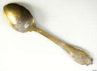 Thespoon is silver toned and is in good and ready to display condition 