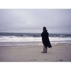 Atlantic Ocean. a Man Stands in Front of the Ocean on a Windy Day 