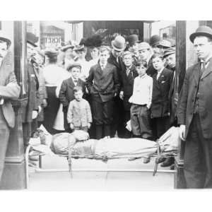  early 1900s photo Harry Houdini strapped to cot, with 