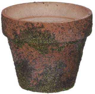   moss covered flower pot makes a beautiful addition to any garden
