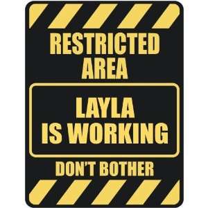   RESTRICTED AREA LAYLA IS WORKING  PARKING SIGN