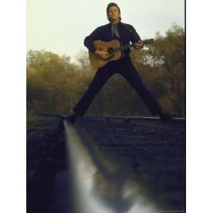  Country/Western Singer Johnny Cash with Guitar Straddling 